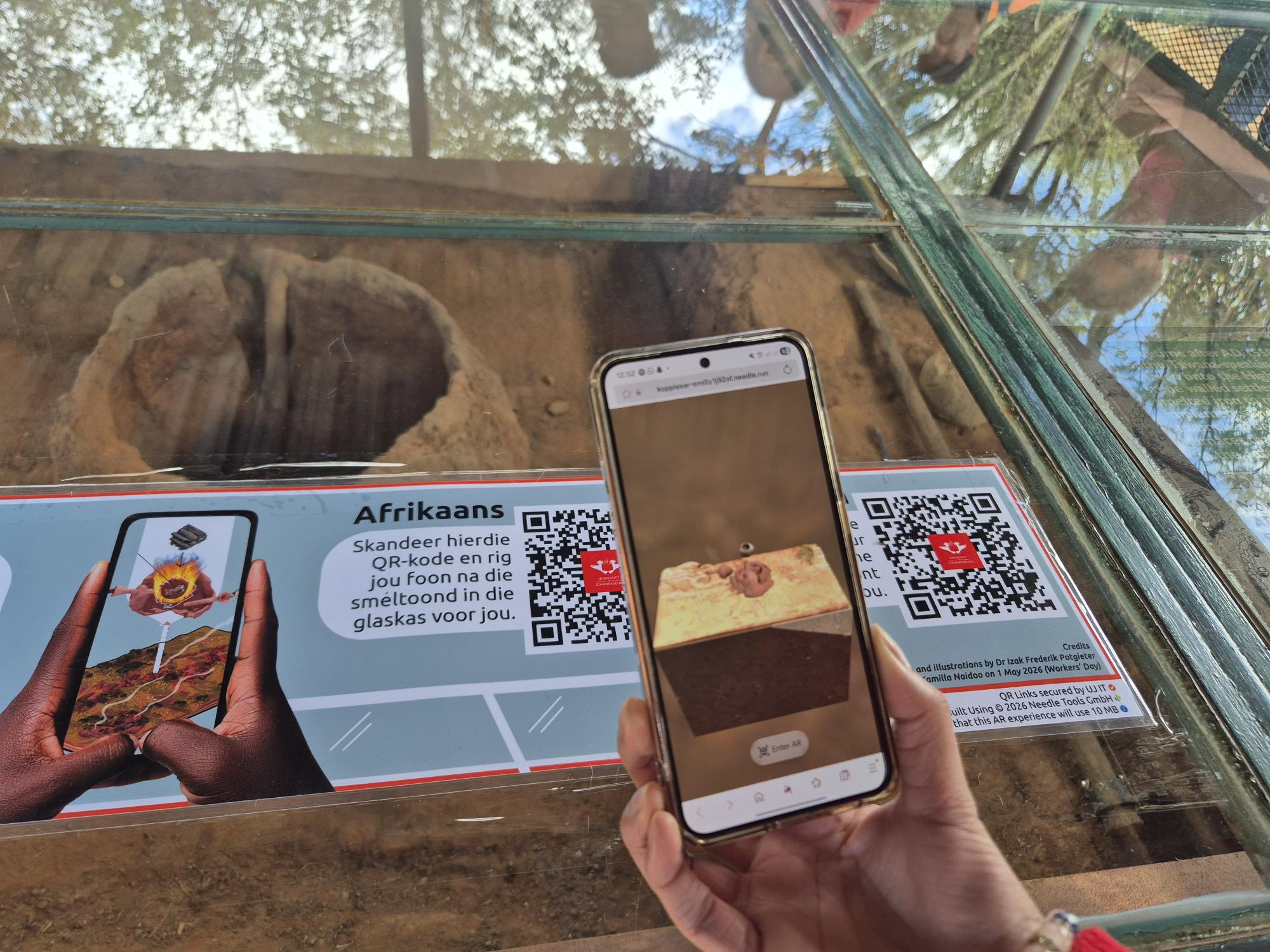 The AR project allows visitors to use their smartphones to see a historically grounded, 3D reconstruction of the ancient smelter digitally overlaid directly onto the existing remains using QR codes.