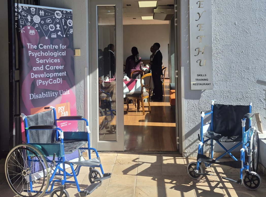 Entrance to The Centre for Psychological Services and Career Development (PsyCaD) Disability Unit with two blue wheelchairs outside the door.