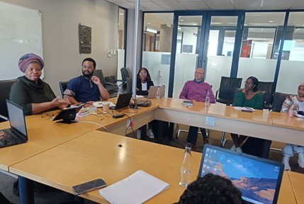 Makhosazana Xaba addressing the workshop. To her left are Prof Ndzendze, Ms Mpondo and Mr Van Zyl and some of the students in attendance. Photo by Joy Mosia.
