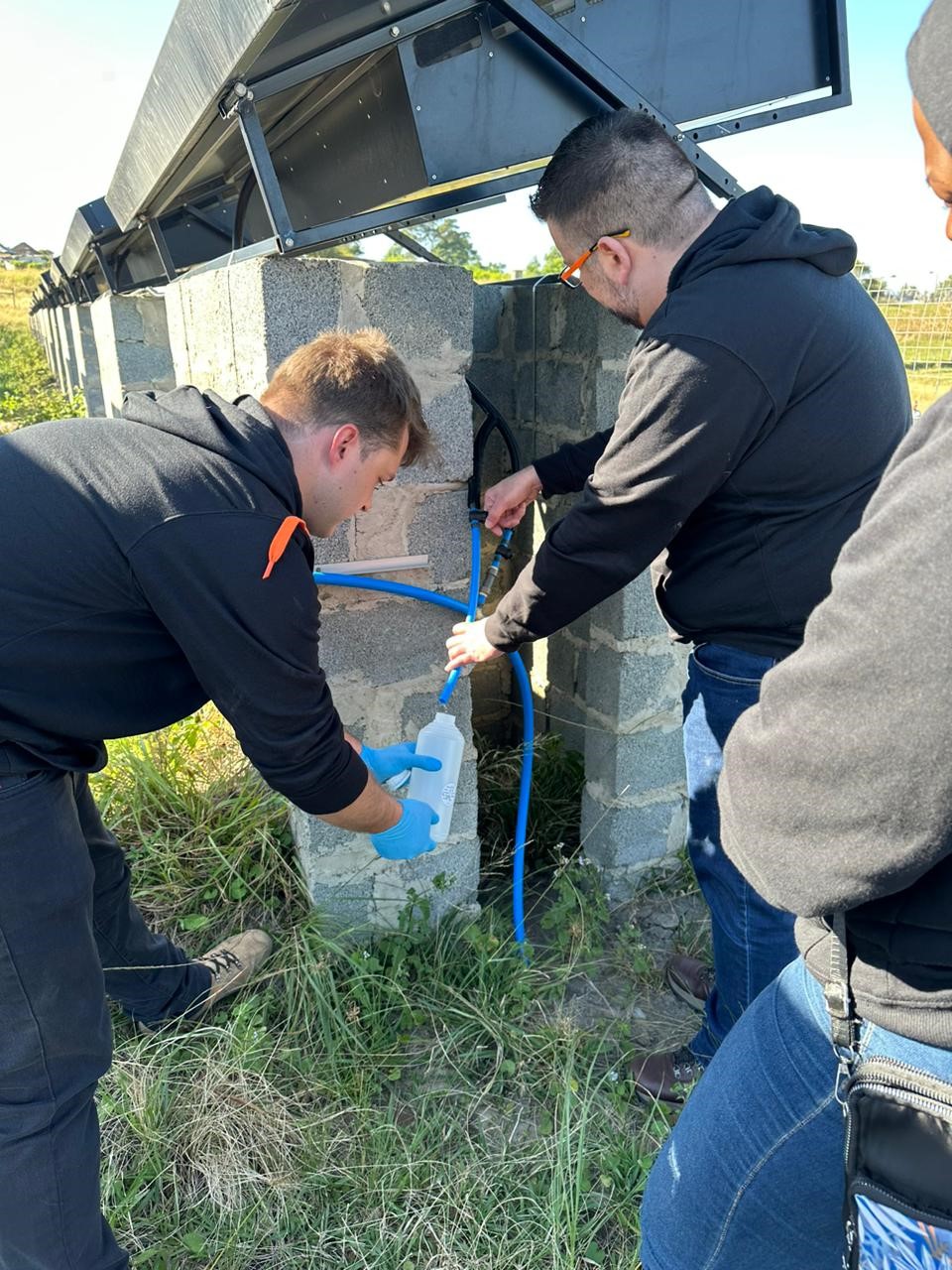 WHRC team members demonstrate how to use the hydropanels to get clean water