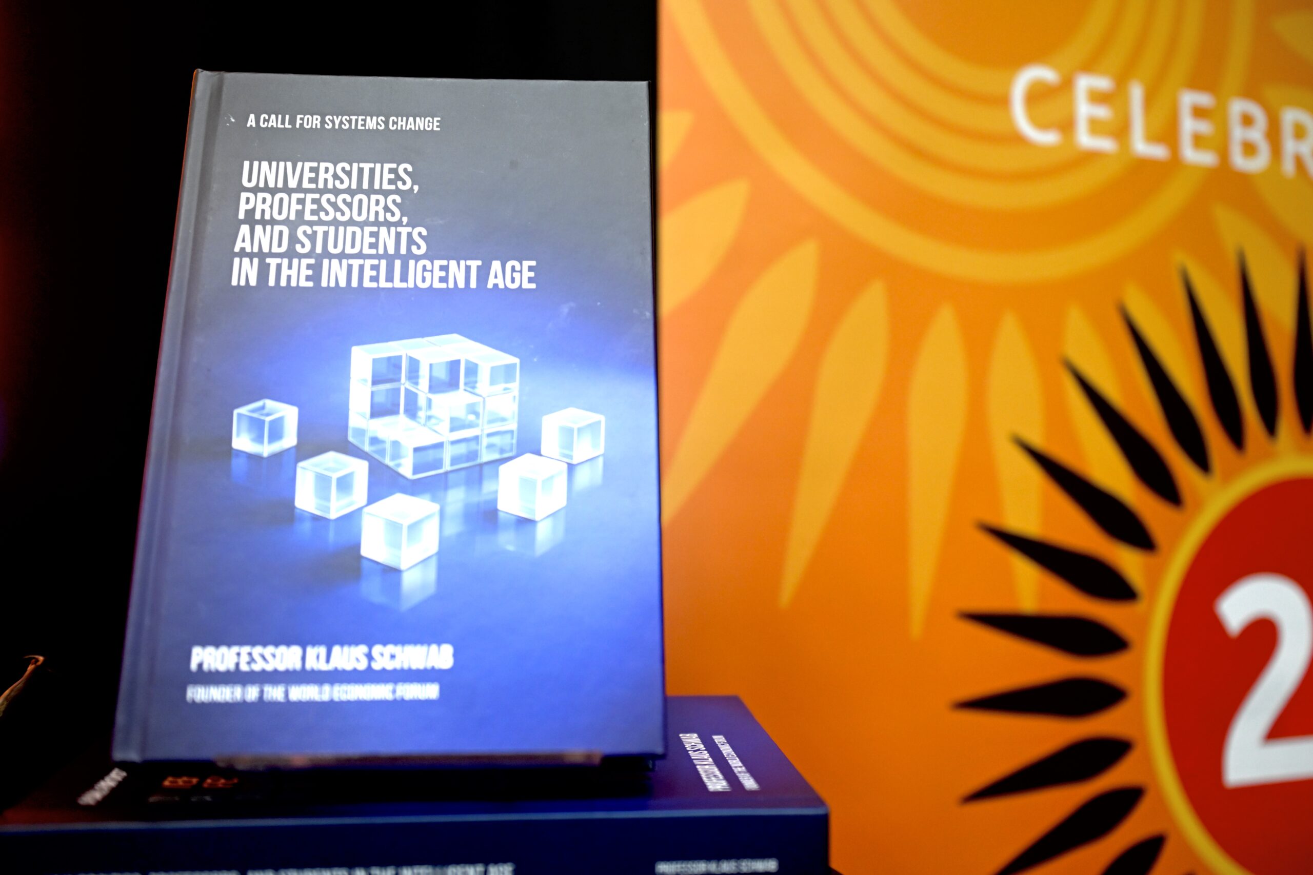 Book cover reads 'Universities, Professors, and Students in the Intelligent Age' with subtitle 'A Call for Systems Change'.